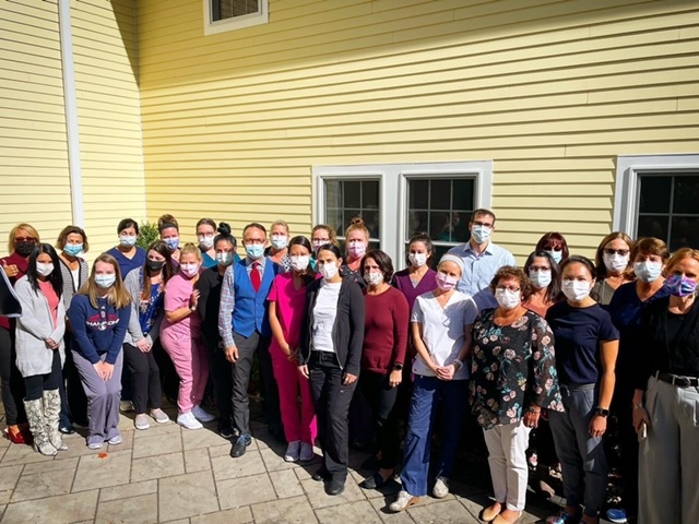a large group of medical professionals standing wearing masks