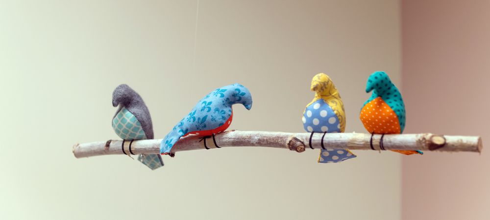 crochet birds on a hanging stick in an exam room