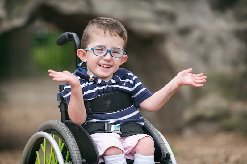 Boy in wheelchair claps