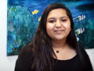 thyroid patient in front of mural