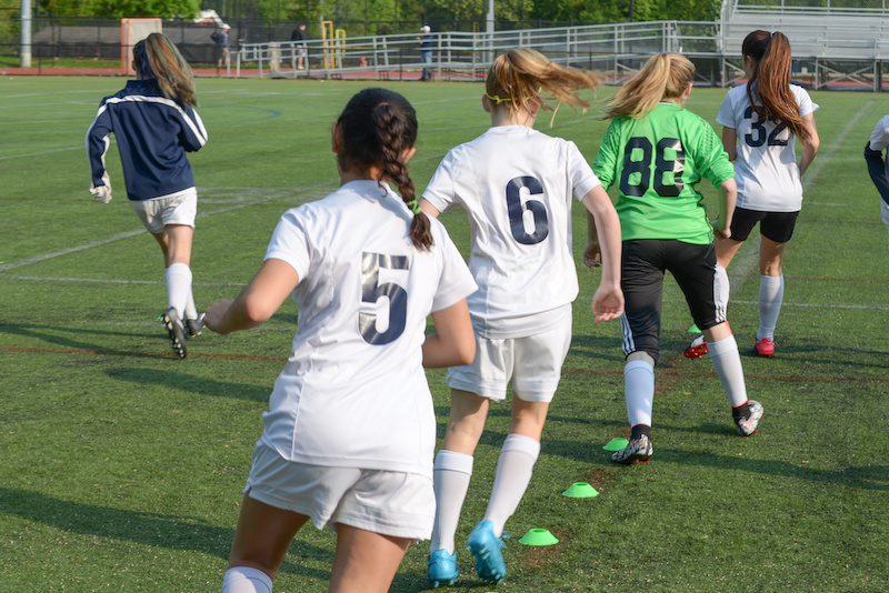 Girls' soccer players take part in pre-practice drills