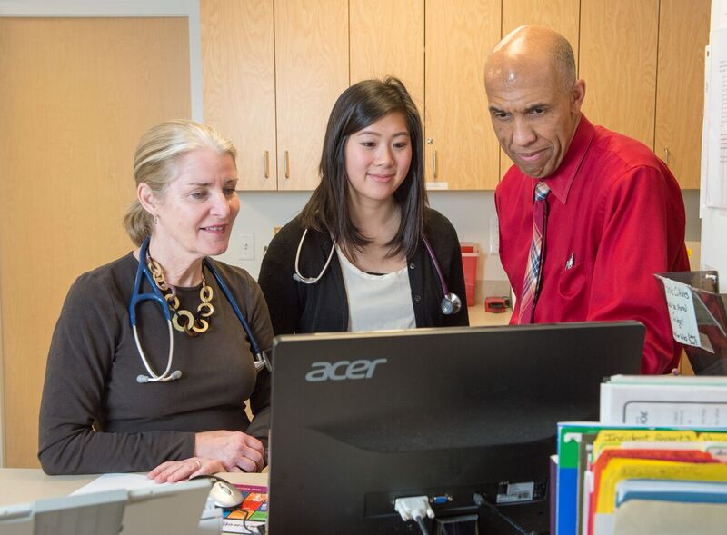 Medical professionals consult information on computer