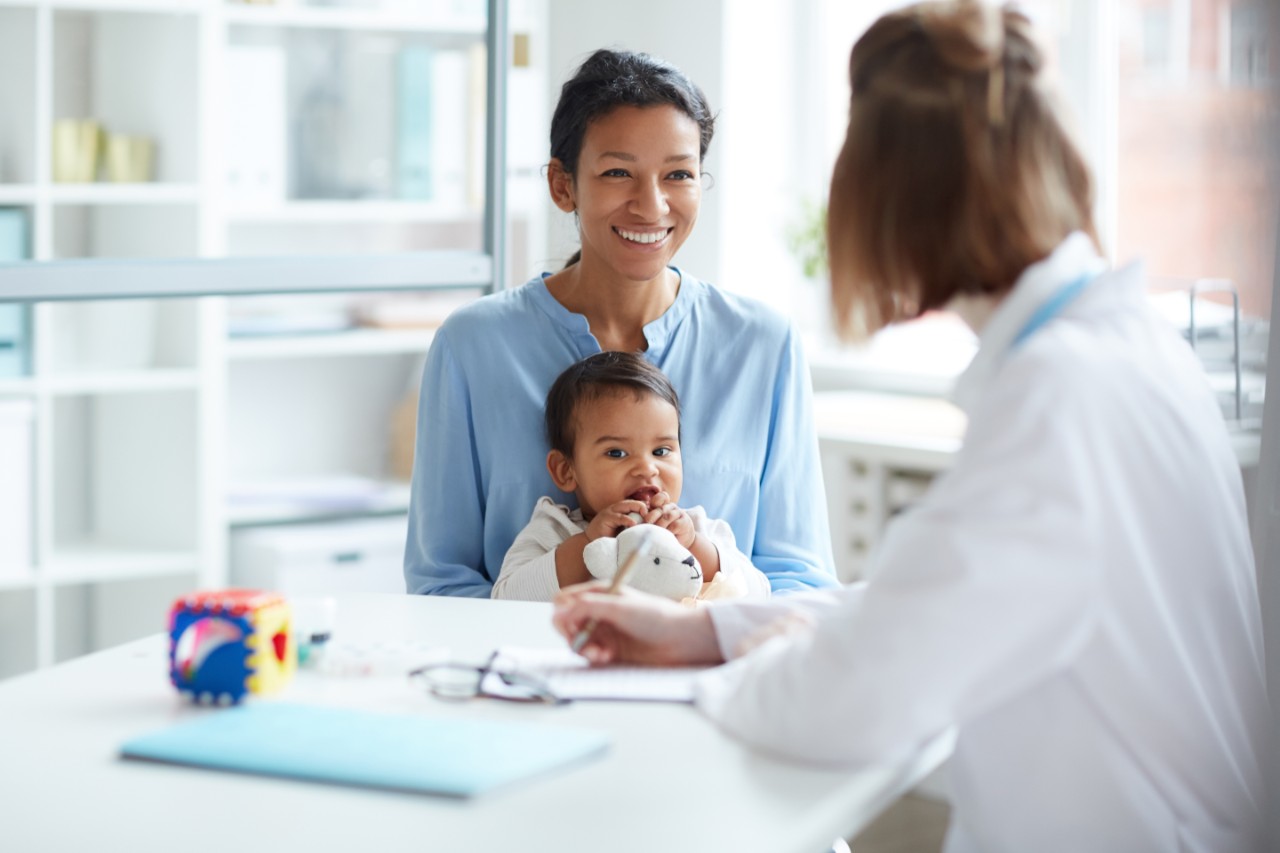 Mom and baby meet with doctor