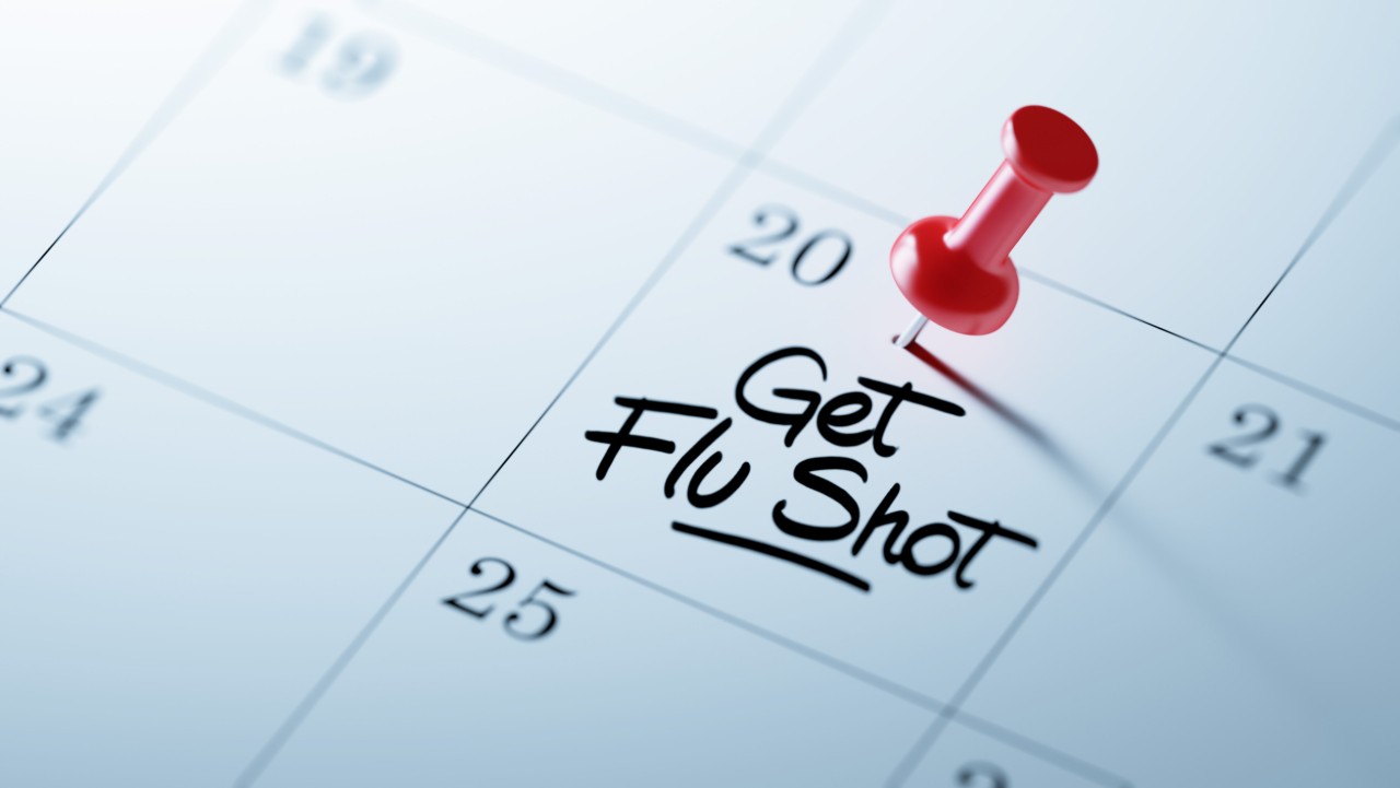 Calendar with reminder note: "Get flu shot"