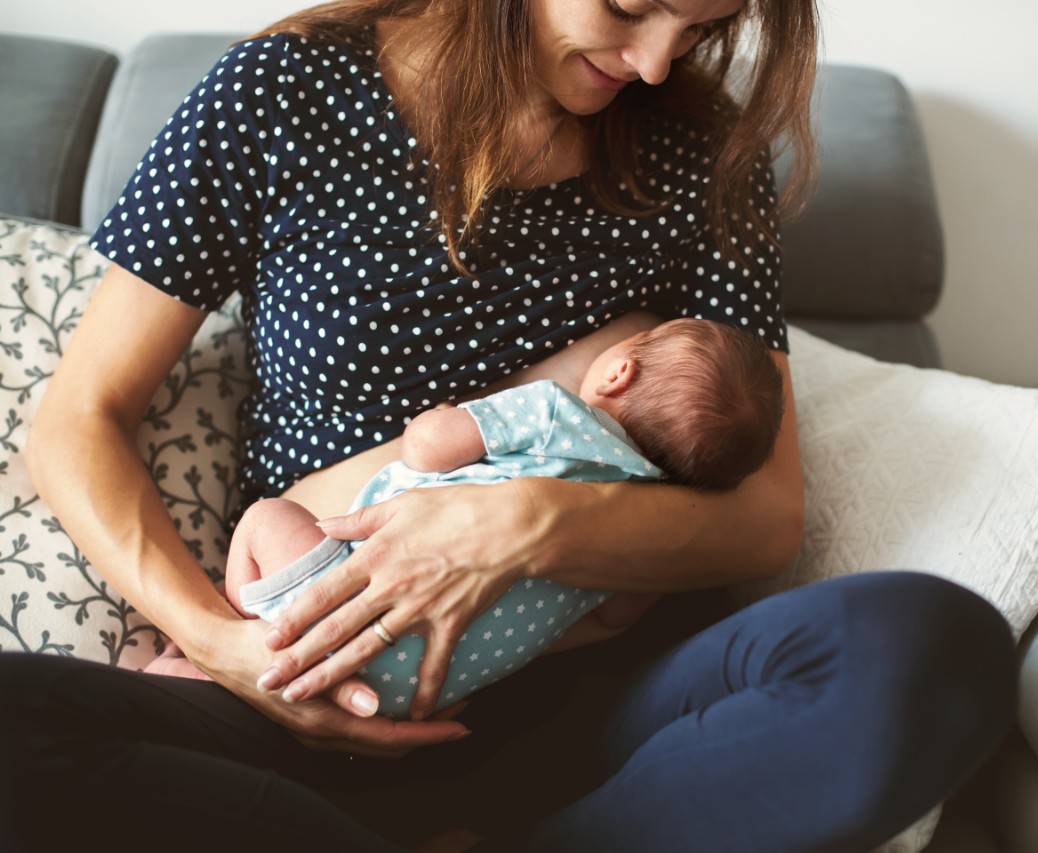 Woman breastfeeds baby