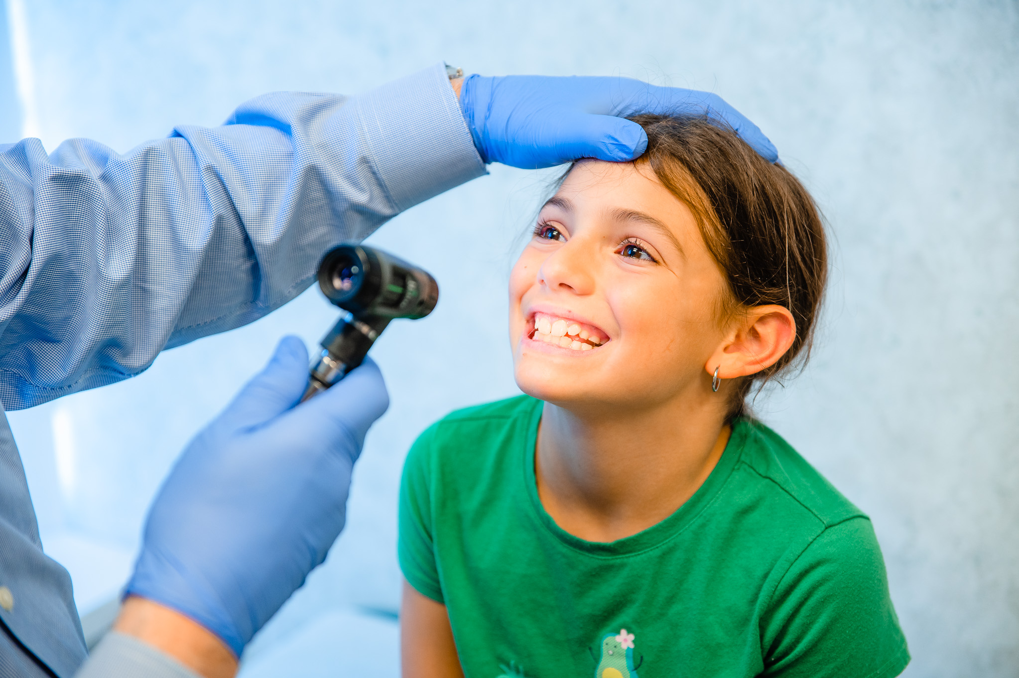 Clinician examines young girl's mouth