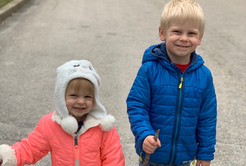 Anabella stands next to her brother.