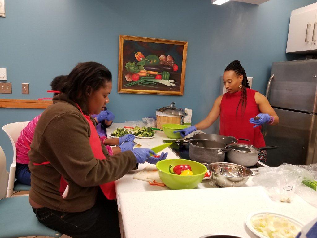 women prepare healthy meals that include vegetables