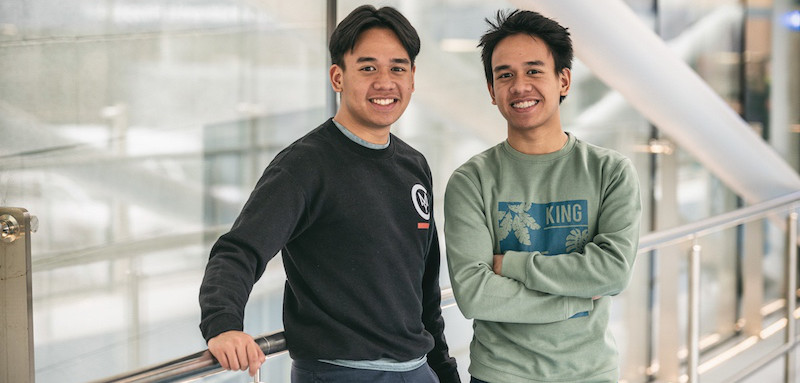 Smiling teen boys pose on skybridge