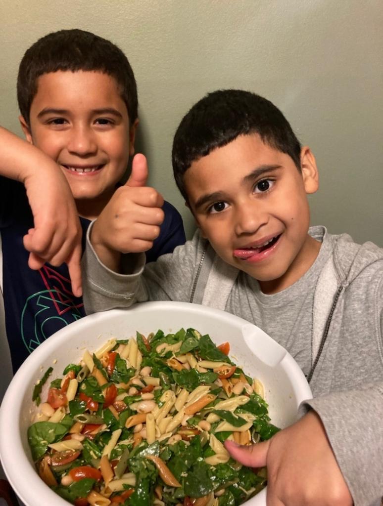 Boys smile while showing off healthy meal