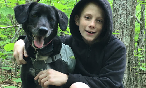 Gavin, a Boston Children's patient, with his black dog