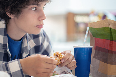 Boy eating fast food