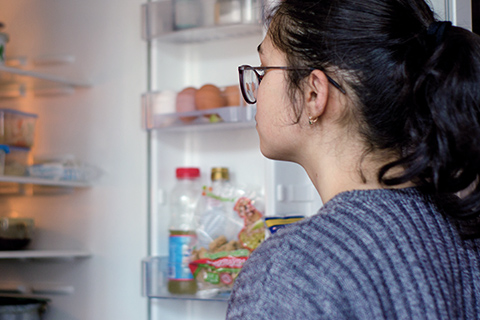 Girl looking in refrigerator