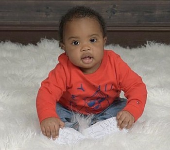 Boy sits on blanket