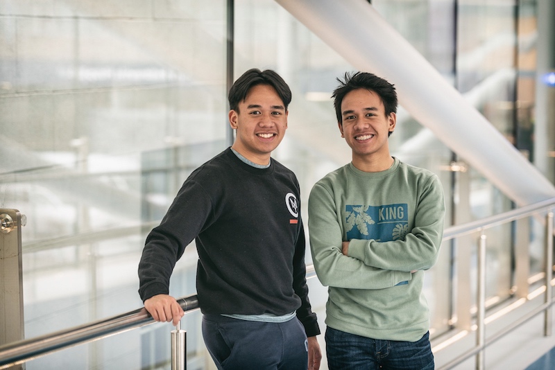 2 male hemophilia patients standing on hospital bridge