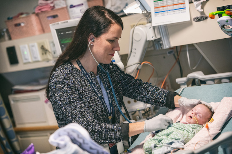 doctor checking on patient in the NICU