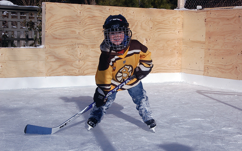 Boy on skates in an outdoor hockey rink