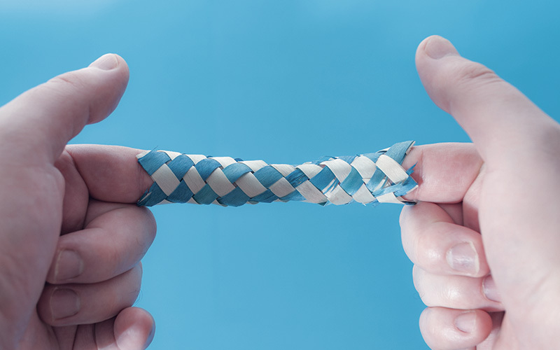 Photo of child playing with Chinese finger trap