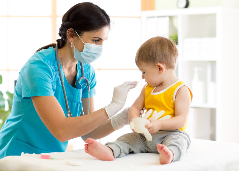 a pediatrician preparing to give a boy a shot