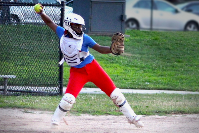 Gwen, a softball catcher, throws to a base.