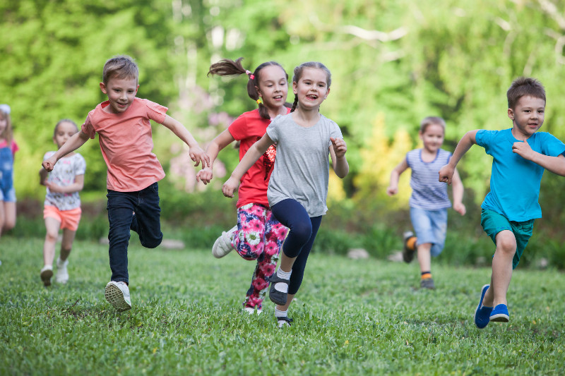 children running through the grass