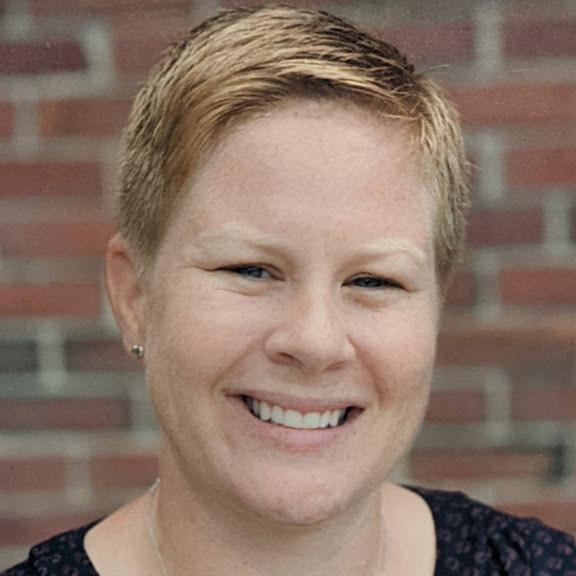 a headshot of a smiling woman