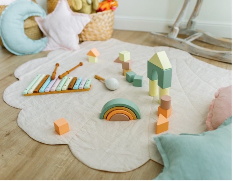 Pastel baby toys on a blanket