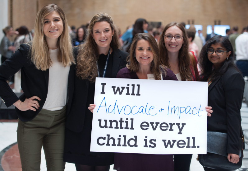 Five women hold sign reading: "I will advocate and impact until every child is well."