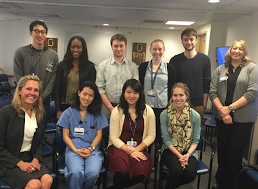 ten men and women sitting and standing