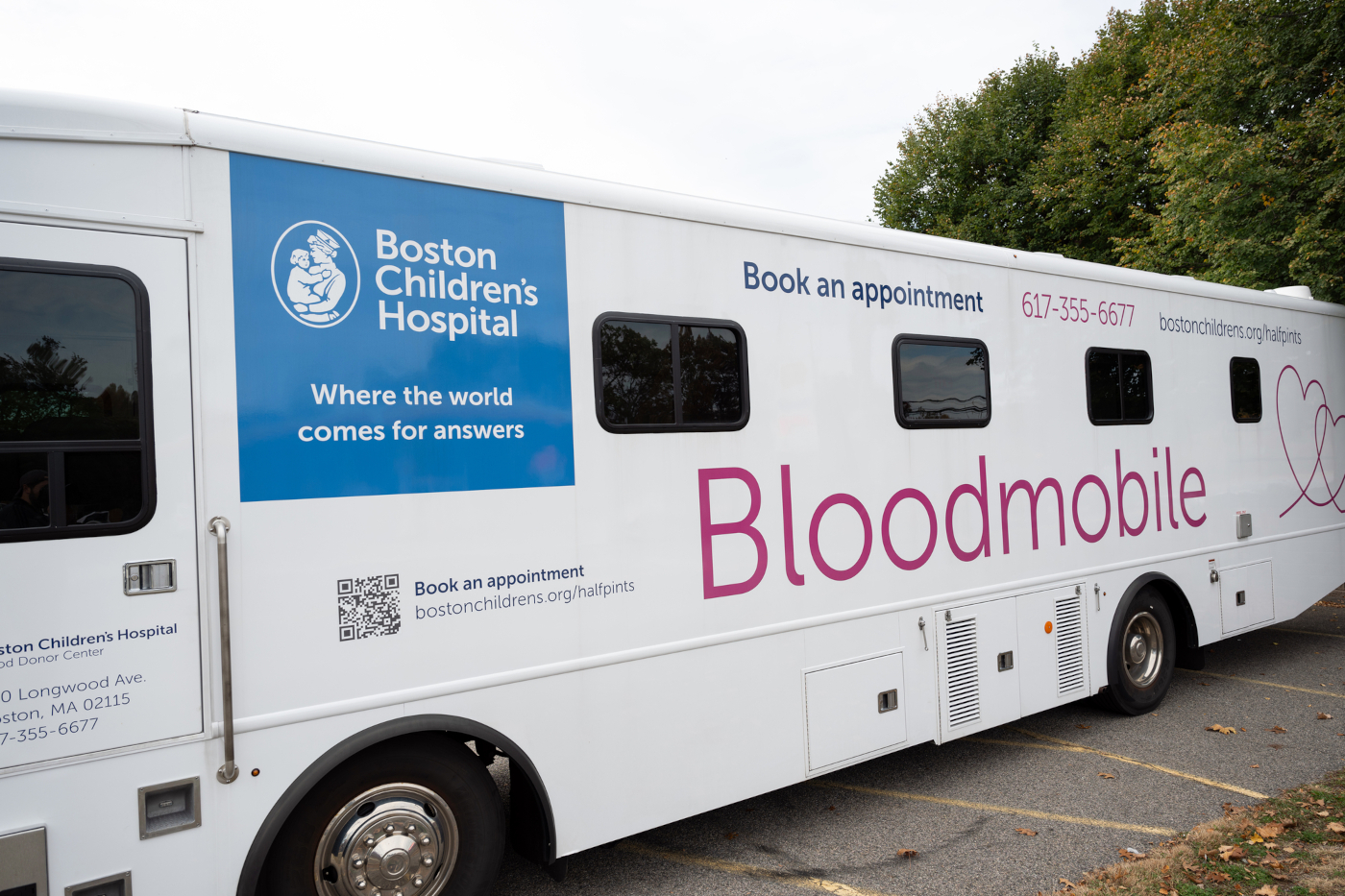 Image of exterior of Bloodmobile: Text: "Boston Children's Hospital: Where the World Comes for Answers," "Book an Appointment," 617-355-6677