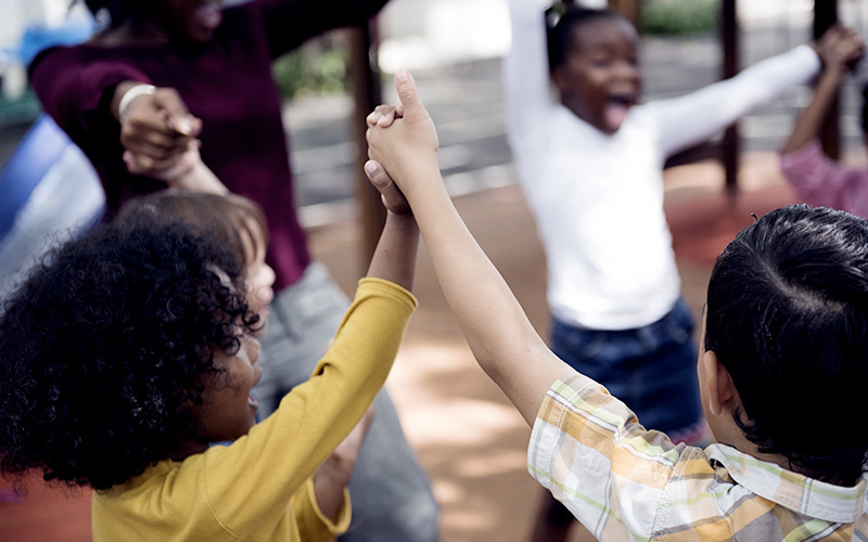 Multi-ethnic children holding hands