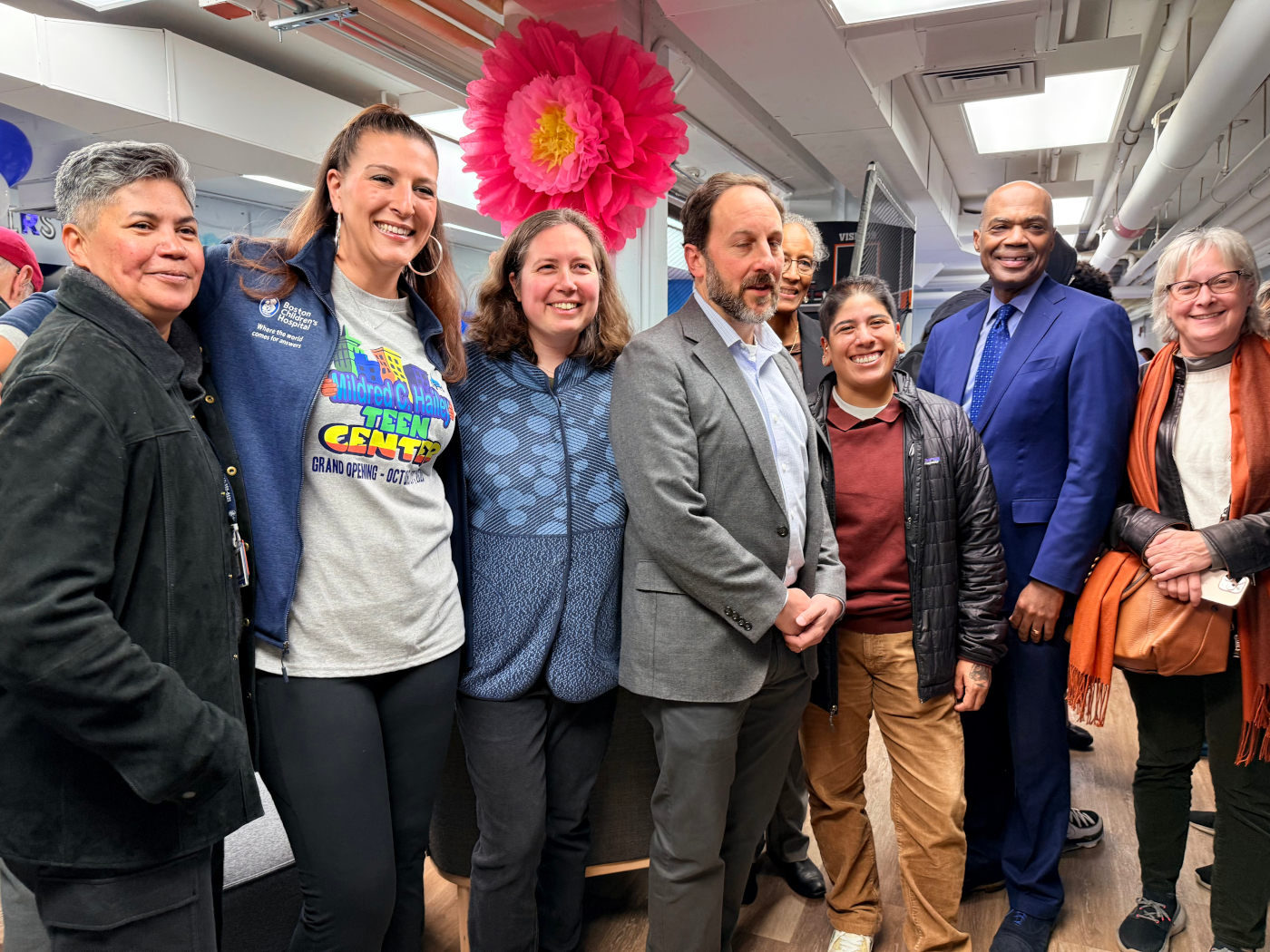 Eight adults pose for group photo.