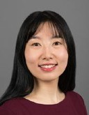 Headshot of Jingyuan Zhang, an asian woman with long dark hair who is smiling at the camera.