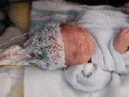 Sleeping baby wears hat