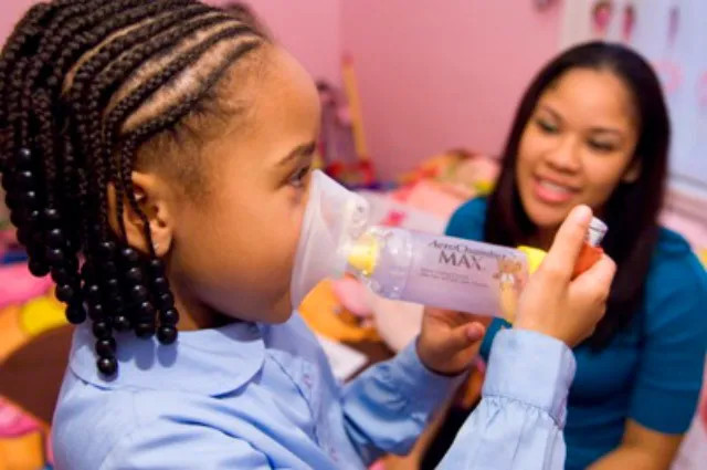 Girl blows into device to measure asthma