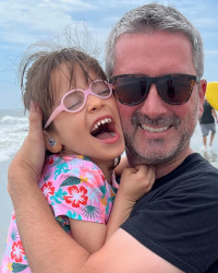 Kevin Flynn holds his daughter in his arms