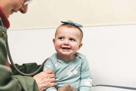 a smiling girl at the pediatrician's office