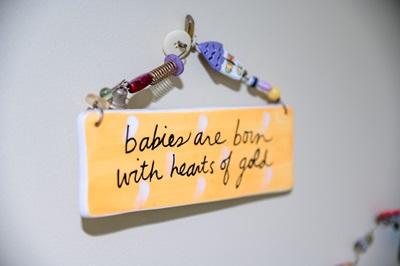 sign that says babies are born with hearts of gold