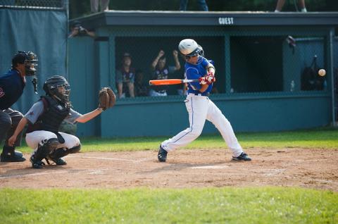 Little League player takes a swing at bat