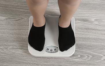 Child with feet on scale