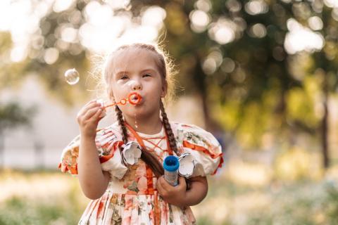 Girl blows bubbles