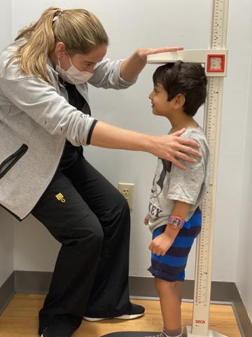 Clinician measures boy's height
