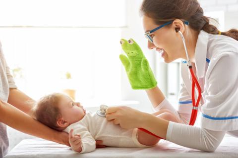 Clinician touches baby's onesie