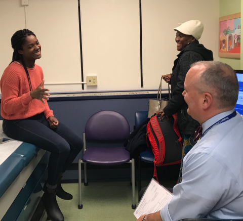 patient talking with parent and doctor