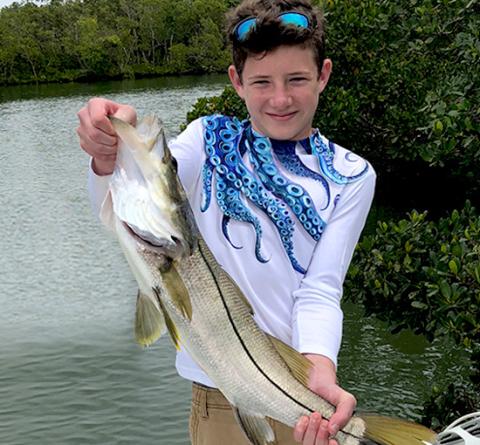 Boy holds big fish