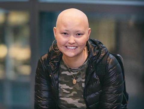 Smiling teen girl with no hair