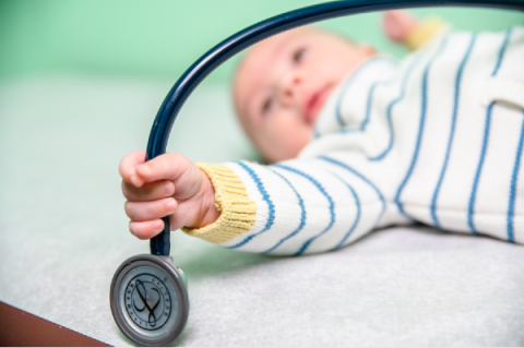 baby holding a stethoscope