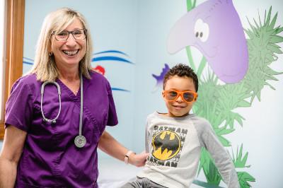 a boy wearing cool glasses and a pediatrician