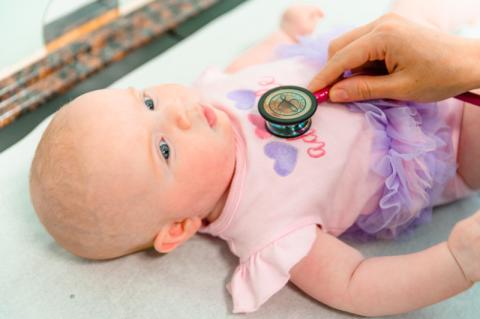 baby with a stethoscope on her chest
