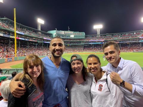 Cardiology fellows pose at Fenway Park with field behind them